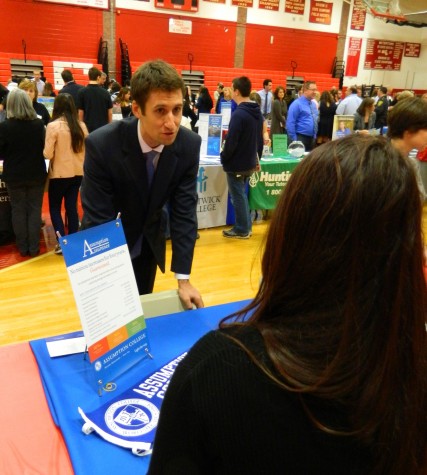 Alphabetically speaking, the Assumption College table was one of the first stops for prospective applicants at the Watertown High School College Fair on Oct. 9, 2014. 
