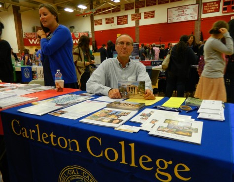 Patrick Field, an alumni rep for Carleton College, works his alma mater's table at the annual College Fair at Watertown High School on Oct. 9, 2014. 