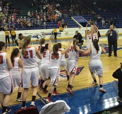 The Watertown girls' basketball team rushes the court to celebrate with seniors Gianna Coppola (14) and Rachel Morris (4)  after the Raiders won the Division 2 North championship at Tsongas Center in Lowell on Saturday, March 7, 2015. Watertown beat Pentucket, 44-40, to advance to the MIAA's Eastern Mass. title game against undefeated Duxbury on Tuesday, March 10, at TD Garden.  
