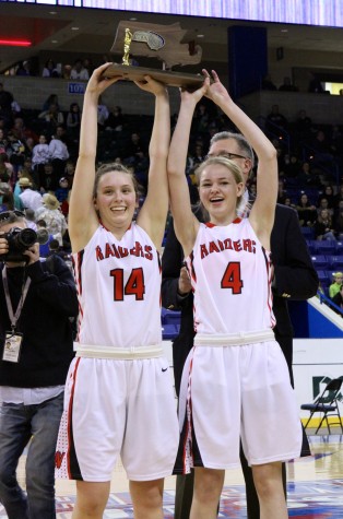 Seniors Gianna Coppola (14) and Rachel Morris (4) hold up the Division 2 North championship trophy at Tsongas Center in Lowell on Saturday, March 7, 2015. Watertown High beat Pentucket, 44-40, to advance to the state semifinal game against undefeated Duxbury on Tuesday, March 10, at TD Garden.  