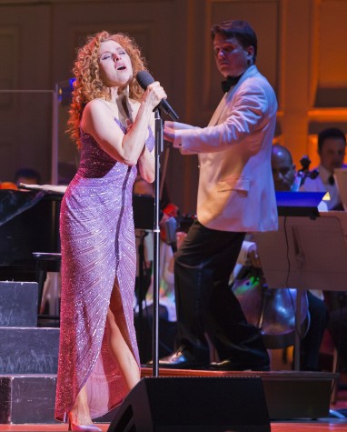Bernadette Peters (left) helps Keith Lockhart celebrate his 20th year conducting the Boston Pops during a concert at Symphony Hall in Boston on Wednesday, May 6, 2015.