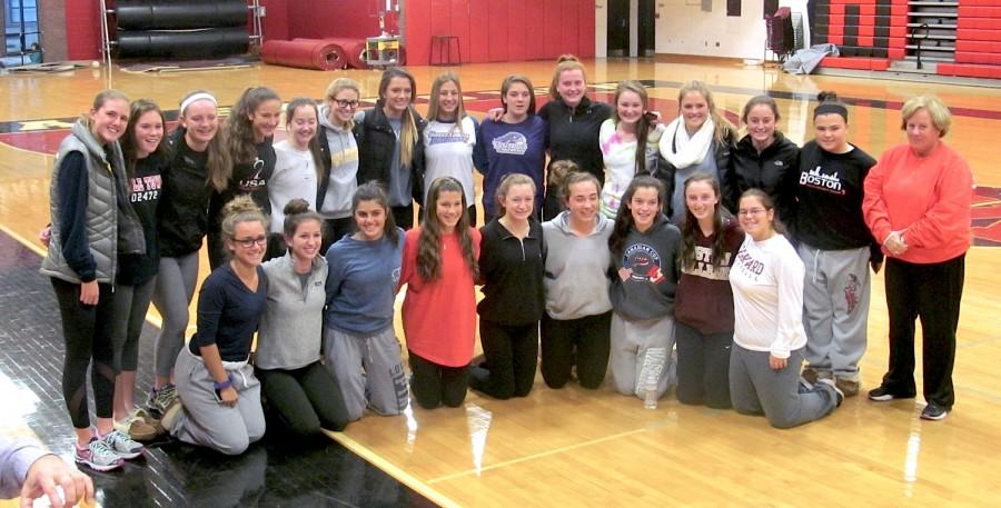 The Watertown High field hockey team -- owners of a national-record 157-game unbeaten streak -- surround Mikayla Paone and Michaela Antonellis (back row center) at their letter of intent signing ceremony in the WHS gym on Thursday, Nov. 12, 2015. Paone will be playing next year for UMass-Loweel, and Antonellis for Stonehill.