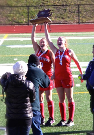 Captains Michaela Antonellis (left) and Ally McCall celebrate with their trophy after the Watertown field hockey team won the MIAA Division 2 state championship on Saturday, Nov. 21, 2015, in Worcester. The Raiders beat Auburn, 6-0, for their seventh straight MIAA state championship while extending their national-record unbeaten streak to 160 games.