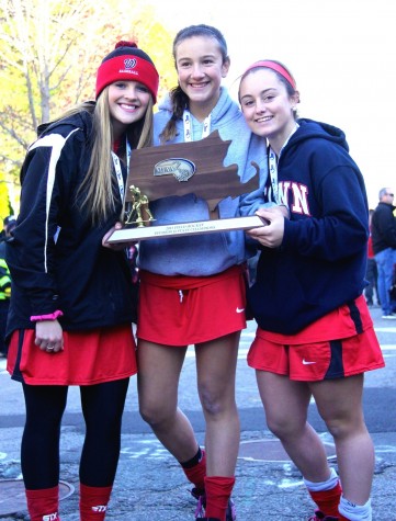 Members of the Watertown field hockey team celebrate at the high school after winning the MIAA Division 2 state championship on Saturday, Nov. 21, 2015, in Worcester. The Raiders beat Auburn, 6-0, for their seventh straight MIAA state championship while extending their national-record unbeaten streak to 160 games.