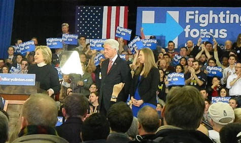 Bill Clinton and his daughter Chelsea stand on a podium at Southern New Hampshire University while presidential candidate Hillary Clinton speaks at her post-election party following the New Hampshire primary on Feb. 9, 2016.