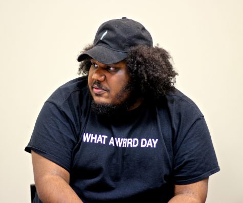 Michael Christmas, who will be performing at the 2016 Boston Calling Music Festival in May, listens to journalism students from Boston-area high schools during a music panel at the Boston Globe.