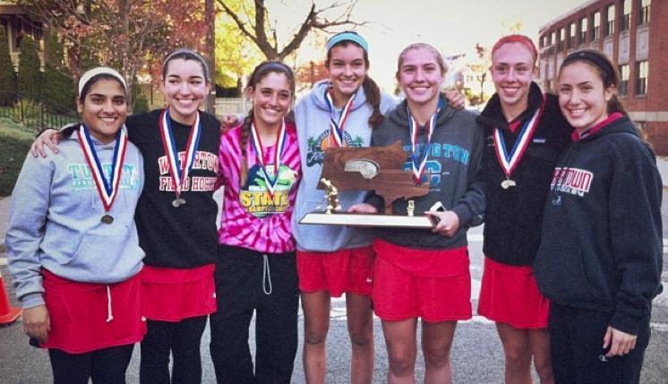 Some members of the Watertown field hockey team pose with the Division 2 state title trophy.