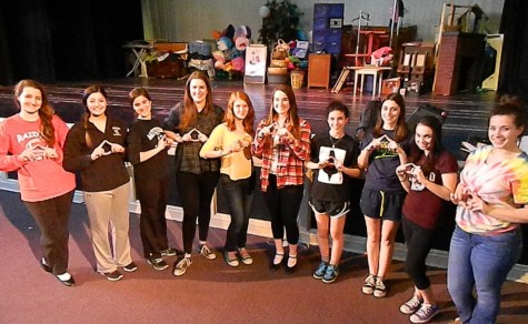 Cast members from “Legally Blonde: The Musical” show their affection for the Delta Nu sorority during a break in rehearsal. The show will hit the Watertown High stage March 6-8, 2014.
