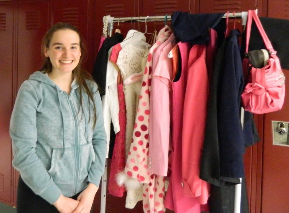Mary Breen stands by the rack holding some of the costumes to be worn by her character, Elle Woods, in Legally Blonde: The Musical when it debuts Thursday night at Watertown High School. Performances are scheduled Thursday, Friday, and Saturday at 7 p.m., and tickets are available at the door.