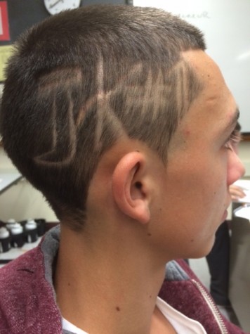 Roman Davis of the Watertown boys' soccer team has the initials and jersey number of teammate Joe Keikian shaved into his head as a show of support for the Raiders goalie who was diagnosed with cancer two weeks ago.