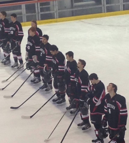 The Watertown High boys' hockey team stands for the national anthem prior to the Division 3 EMass title game at Gallo Arena in Bourne on March 11, 2015. The Raiders beat Norwell, 3-0, to advance to the state championship game on Sunday, March 15, at TD Garden.