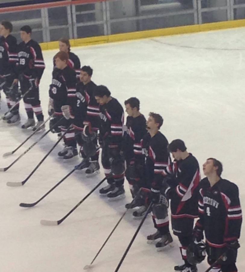 The Watertown High boys hockey team stands for the national anthem prior to the Division 3 EMass title game at Gallo Arena in Bourne on March 11, 2015. The Raiders beat Norwell, 3-0, to advance to the state championship game on Sunday, March 15, at TD Garden.