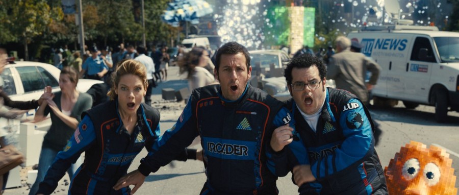 In the new comedy Pixels, (from left) Michelle Monaghan, Adam Sandler, and Josh Gad do their best to save the world from aliens. 