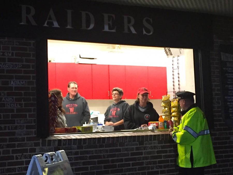 Parents of younger Watertown High football players work at the Victory Field snack shack during football games.