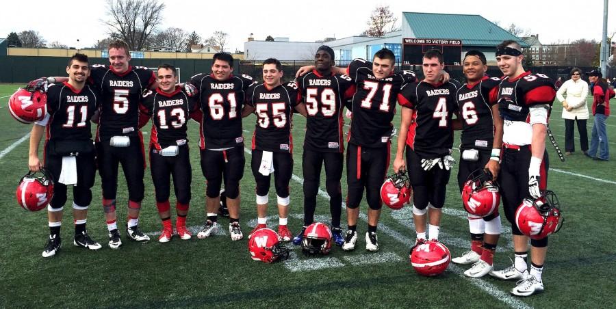 Watertown High seniors pose on Victory Field after playing their last football game for the Raiders, a 24-22 victory over Belmont on Thanksgiving.  From left: Dan Farrar, Kyle Foley, Robert Kennedy, Erick Yax-Vidal, Stevie Mey, Farid Mawanda, Jake Leitner, Tyler Poulin, Luis Moradel, and Barry Dunn. (Nov. 26, 2015)