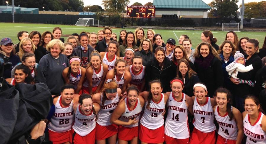 Watertown High School field hockey players past, present, and future celebrate the Raiders’ record-setting 154th game without a loss on Oct. 21, 2015, at Victory Field. 
