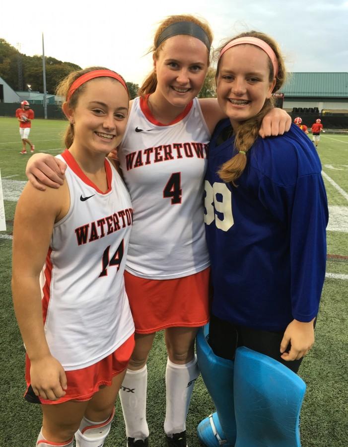 Kourtney Kennedy, Ally McCall, and Jonna Kennedy (let to right) pose following Watertown High field hockeys record-setting 154th field hockey game without a loss Oct. 21, 2015. 