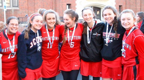 Members of the Watertown field hockey team celebrate outside the high school after winning the MIAA Division 2 state championship on Saturday, Nov. 21, 2015, in Worcester. The Raiders beat Auburn, 6-0, for their seventh straight MIAA state championship while extending their national-record unbeaten streak to 160 games.