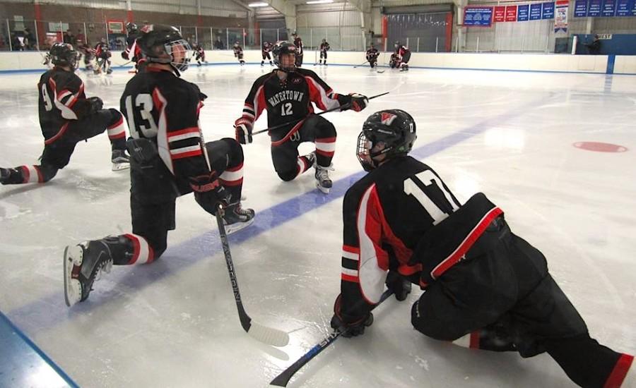 The Watertown High hockey team stretches out prior to its game against host Belmont at Skip Viglirolo Skating Rink on Jan. 27, 2016.