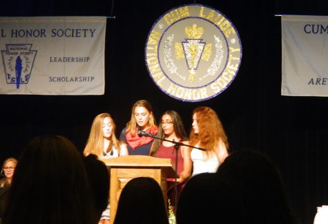 The executive officers of Watertown High's National Honor Society (from left) Alexis Catsoulis, Stella Varnum, Janaki Thangaraj, and Sarah Greim, speak during induction ceremonies Oct. 20, 2016.