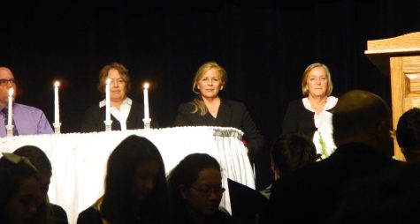 Principal Shirley Lundberg (right) and Dr. Theresa McGuinness (second from right), acting superintendent of the Watertown Public Schools, watch as the Water Tones, the WHS a cappella group, performs during National Honor Society induction ceremonies Oct. 20, 2016. 