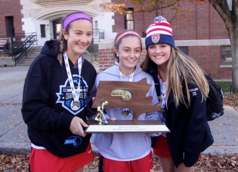 Members of the Watertown field hockey team pose outside the high school with the MIAA Division 2 trophy Nov. 19, 2016. The Raiders defeated Oakmont, 4-3, to win their eighth straight state championship. 