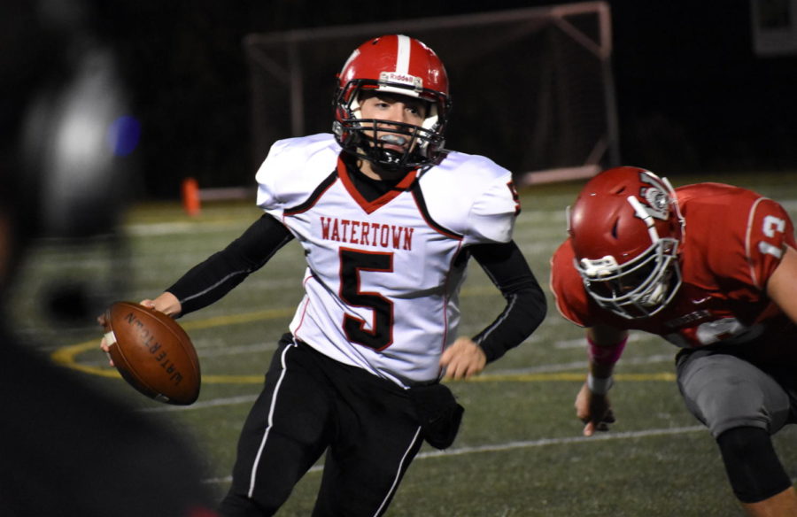 Watertown quarterback Nick McDermott races for the sideline with a Wakefield defender in pursuit. Watertown played at Wakefield on Friday, Oct. 20, 2017, losing to the host Warriors, 21-14, in the last game before the MIAA playoffs. 