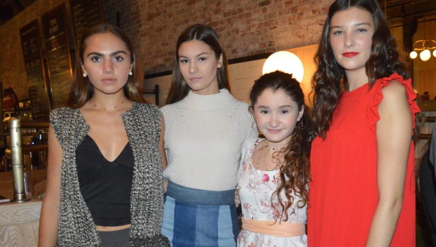 Teen fashion designer Ruby McAloon (second from right) poses at 17+, the opening night event for Boston Fashion Week held at Explorateur in Boston on Oct. 1, 2017.