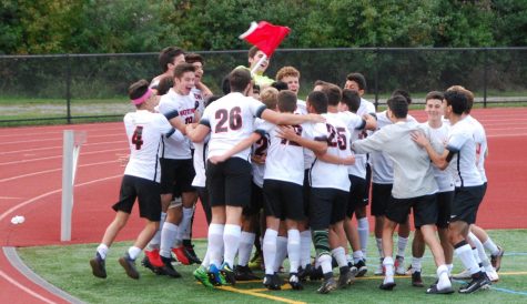 Watertown celebrates with the corner flag after the boys soccer team defeated host Belmont, 4-1, on Saturday, Oct. 6, 2018.
