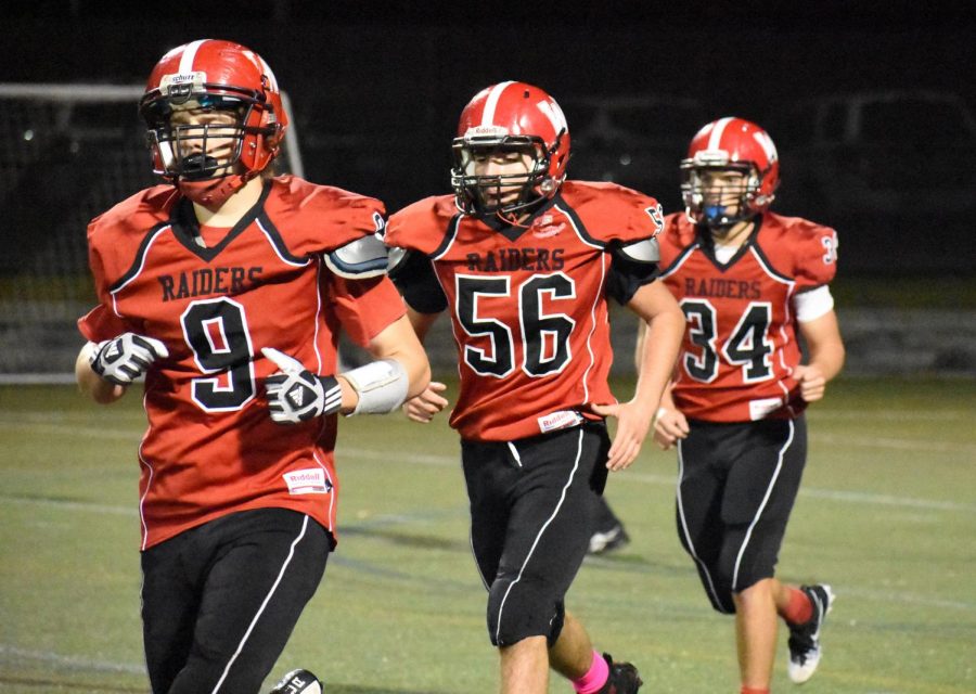 JJ Santos (9), Michael Manoukian (56), and Mason Andrade (34) had their game faces on during Watertowns 51-13 loss to Stoneham at Victory Field on Friday, Oct. 12, 2018.