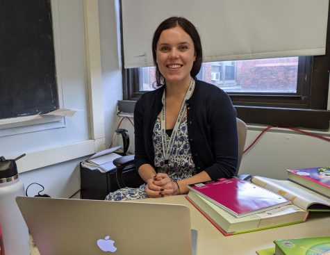 New math teacher Sarah Mepham poses at her desk during her first week at Watertown High School.