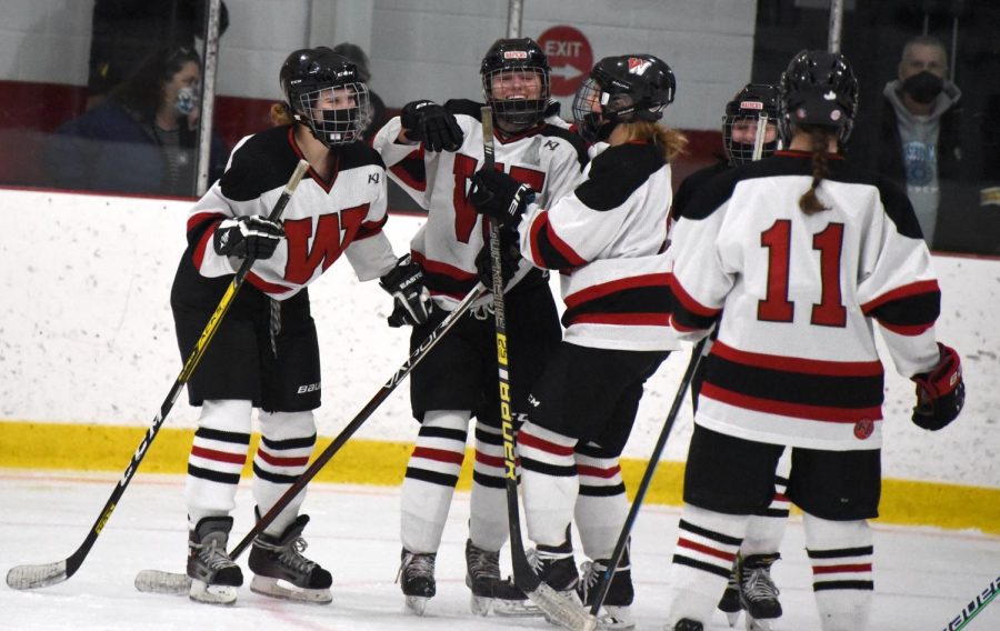 The+Watertown+High+girls+hockey+team+celebrates+a+goal+during+its+6-0+win+over+Melrose+on+Feb.+2%2C+2022%2C+at+John+A.+Ryan+Arena.