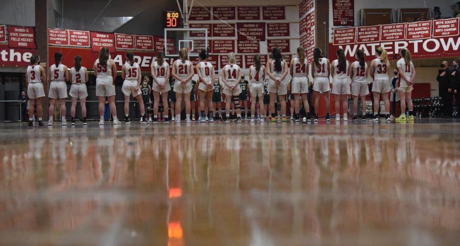 The Watertown High girls basketball team takes a moment to reflect before hosting Ursuline on Feb. 15, 2022. 