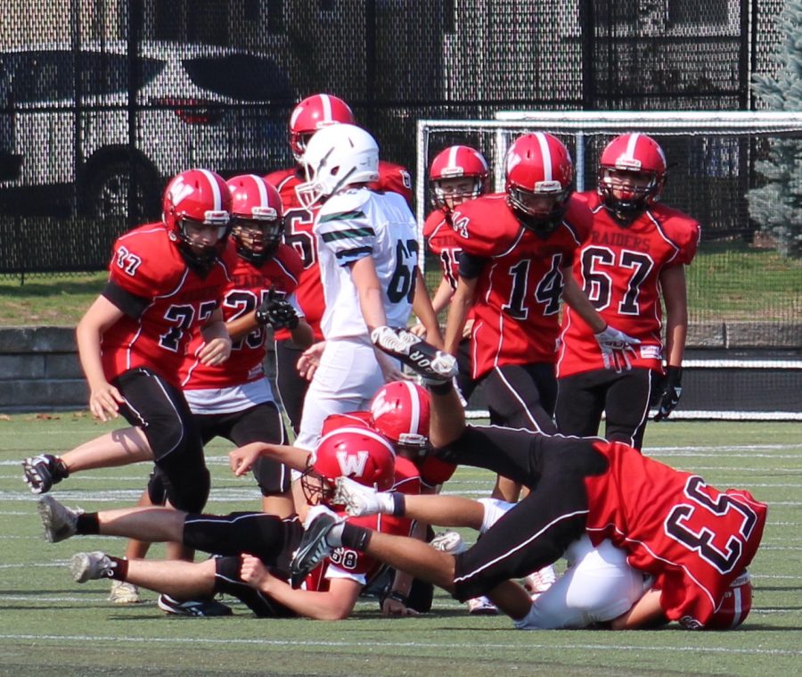 The+Watertown+JV+football+team+%28in+red%29+takes+on+Pentucket+on+Saturday%2C+Sept.+10%2C+2022%2C+at+Victory+Field+in+Watertown.