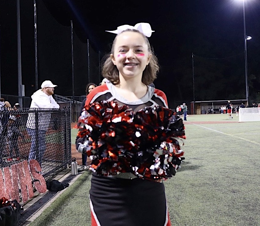 Ali Sevene of the Watertown High School cheerleading team poses during the football game at Victory Field on Sept. 16, 2022.