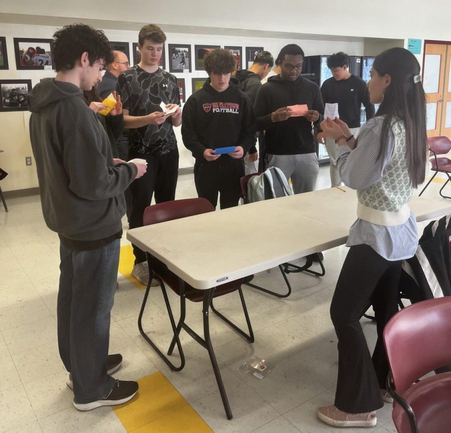 Kingian Club members leading a group of Watertown High students on how to make an origami crane during SPEAK Week 2023. 